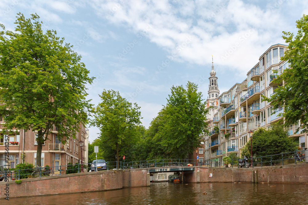 City view of Amsterdam canal, church and typical houses, Holland