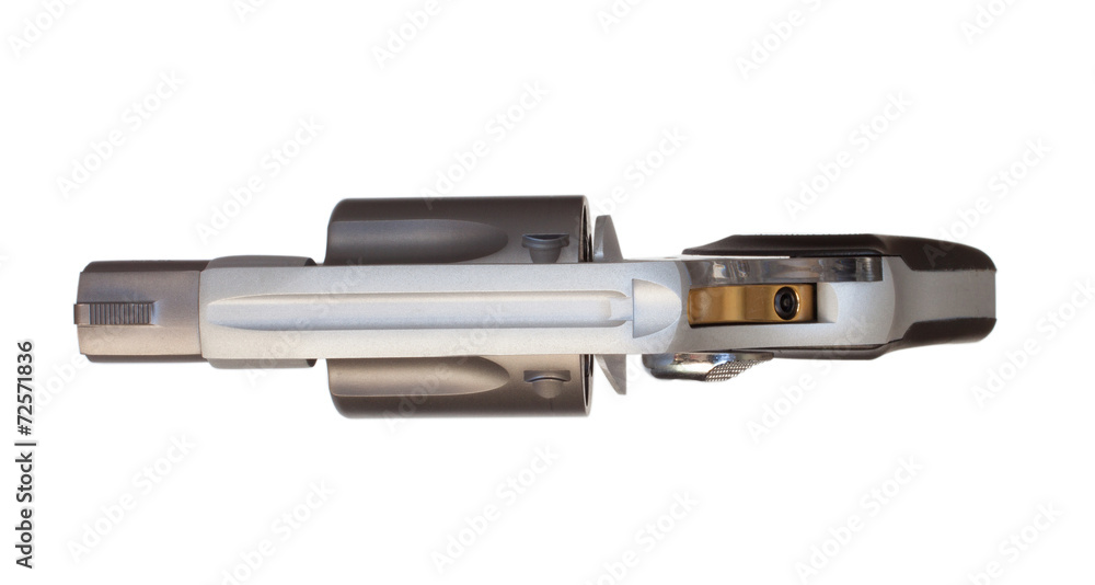Top view of a revolver with a gold colored hammer. Top view of a revolver with a gold colored hammer.