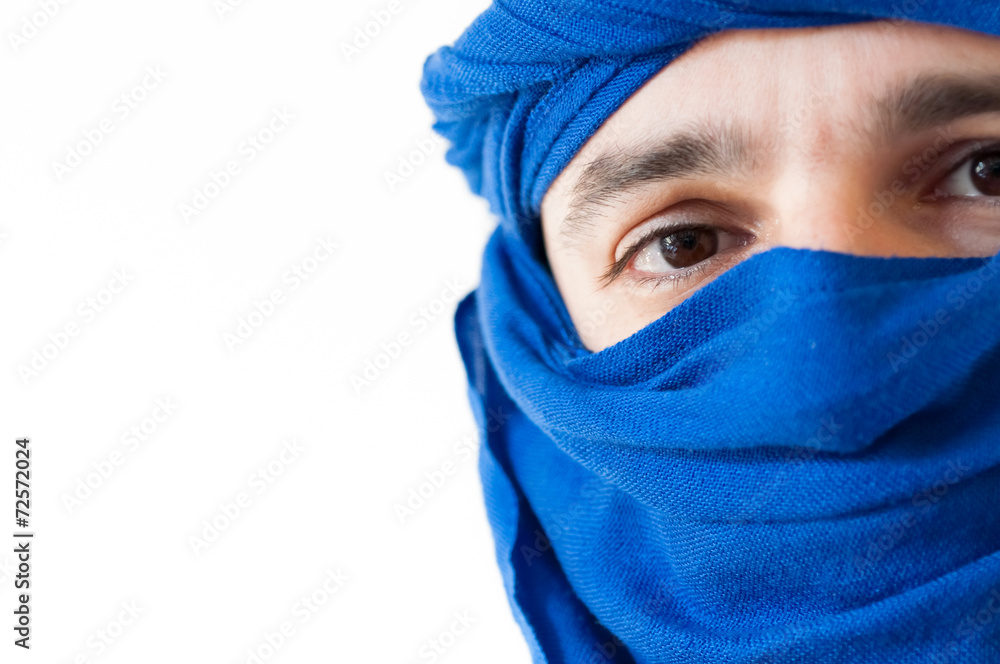 Close up of man wearing a blue keffiyeh against white background Close up of man wearing a blue keffiyeh against white background