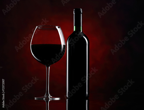 Red wine glass with bottle