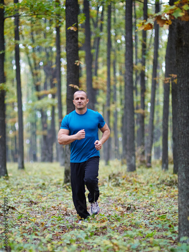 Fototapeta Naklejka Na Ścianę i Meble -  Man jogging in the forest