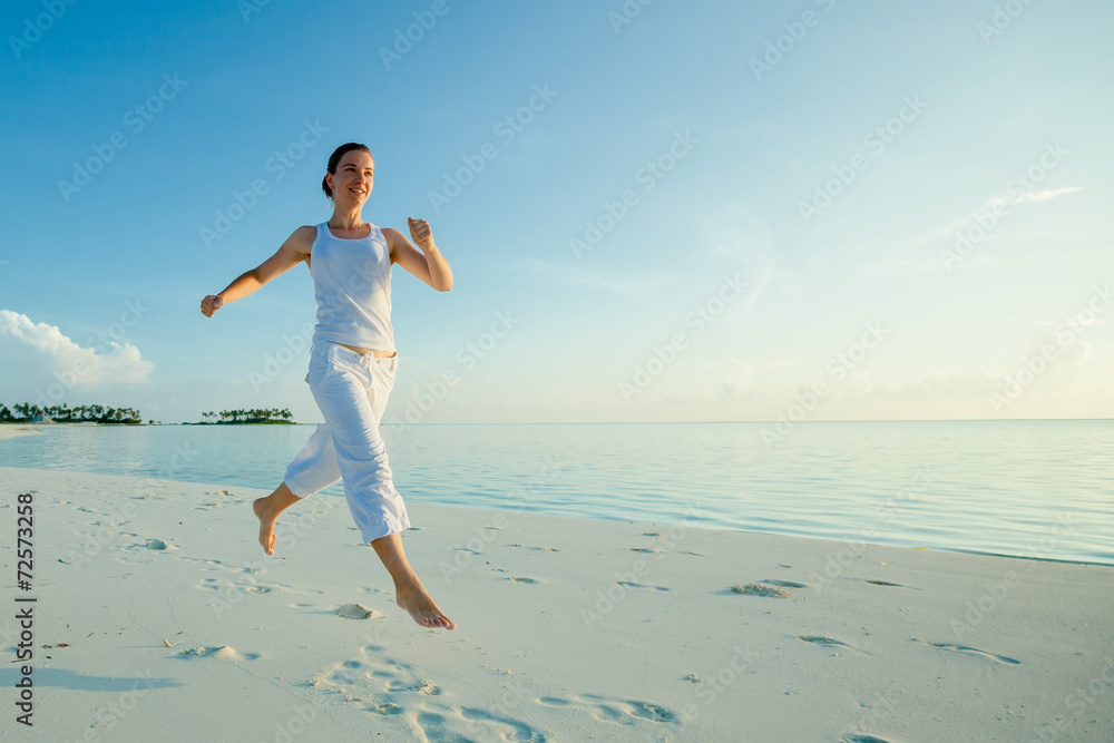 Caucasian woman jogging at the seashore
