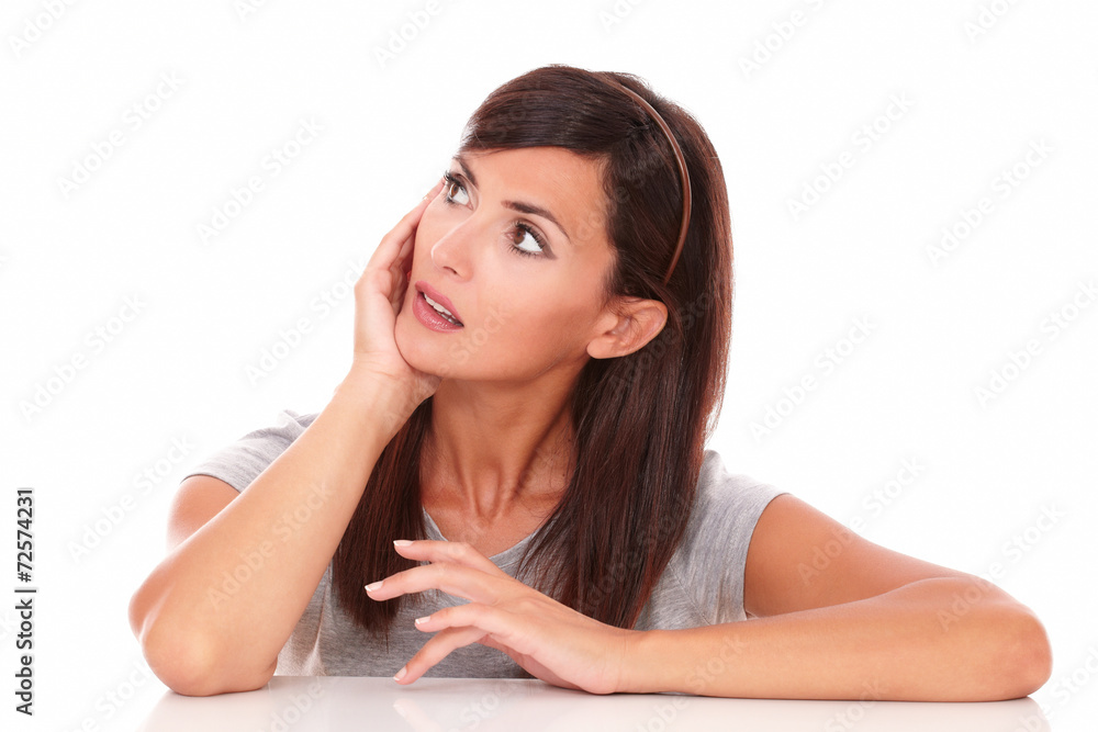 Latin lady wondering while looking to her right up Latin lady wondering while looking to her right up