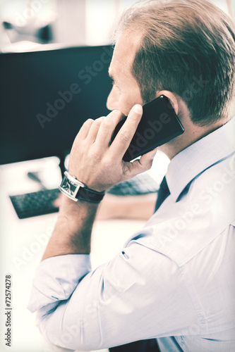businessman with smartphone in office
