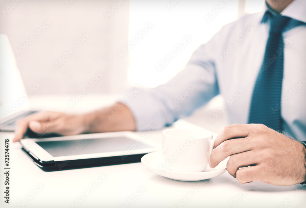 businessman with tablet pc and coffee in office businessman with tablet pc and coffee in office