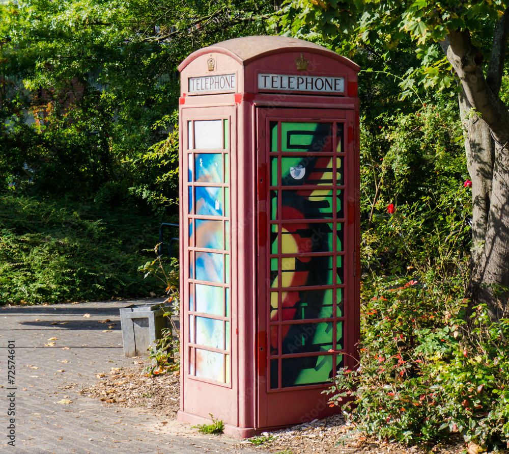 Obraz premium painted old red phone booth, phone box, painted in different col
