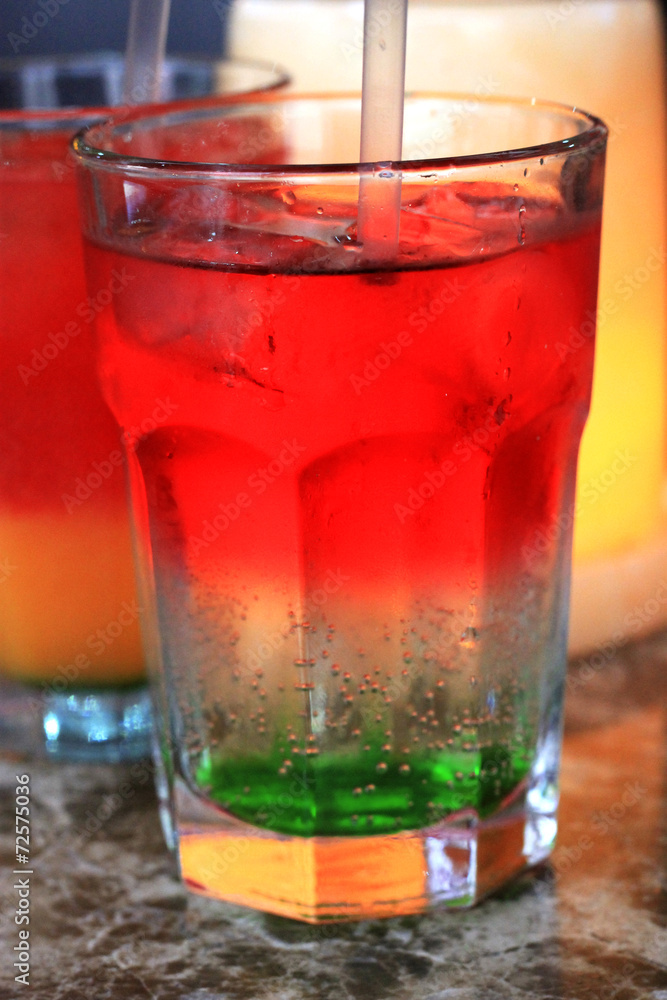 Glass of drink with a straw on the marble table Glass of drink with a straw on the marble table