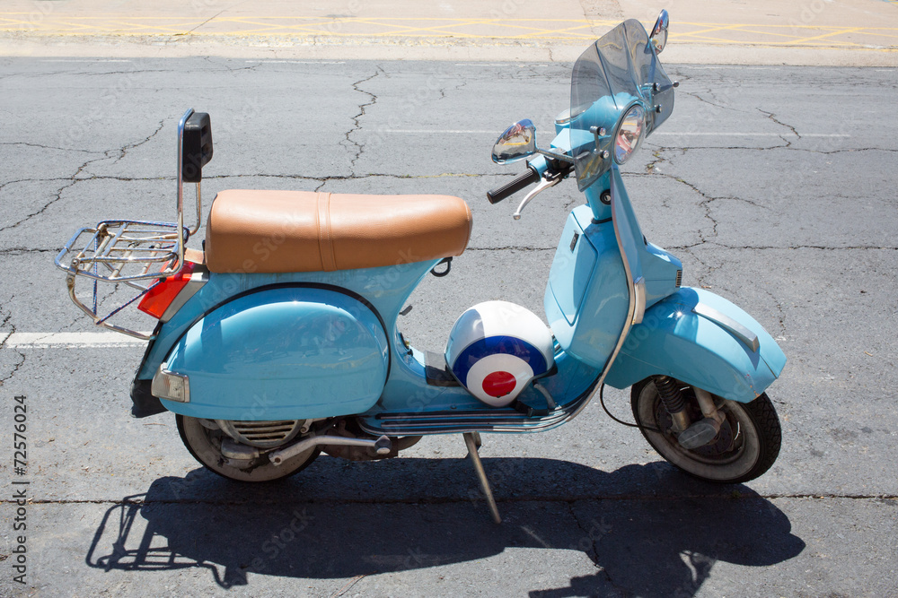 Obraz premium Light blue moped and helmet