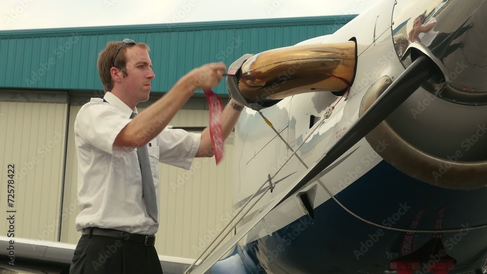 Pilot Attaches Post-Flight Safety Covers Ribbons to Engine Pilot Attaches Post-Flight Safety Covers Ribbons to Engine