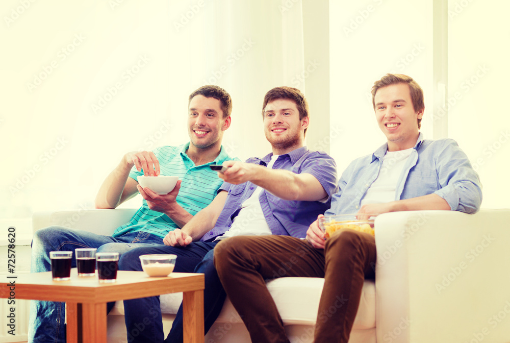 © Syda Productions - smiling friends with remote control at home © Syda Productions - smiling friends with remote control at home