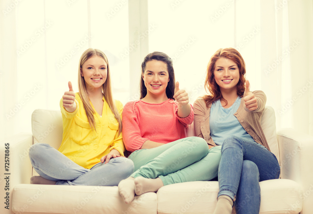three girlfriends showing thumbs up at home three girlfriends showing thumbs up at home