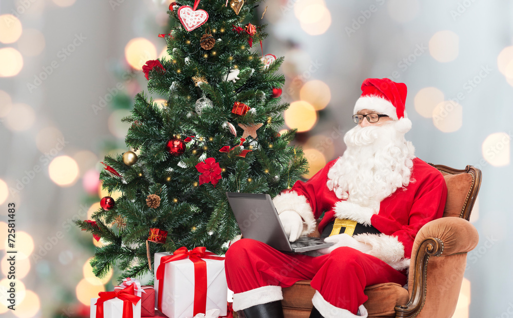 man in costume of santa claus with laptop man in costume of santa claus with laptop