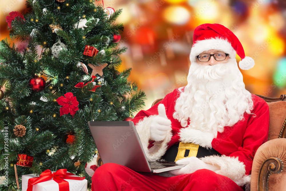 man in costume of santa claus with laptop man in costume of santa claus with laptop
