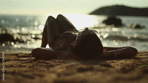 Beautiful woman sunbathing on a beach