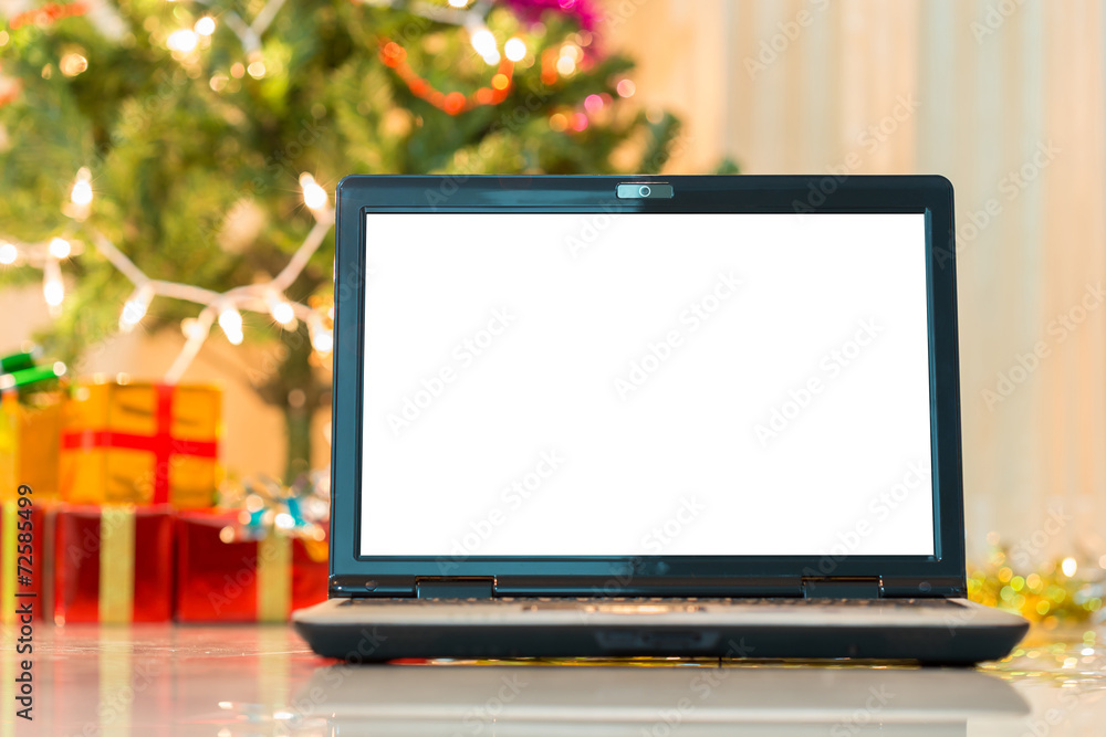 laptop with gift box and christmas lights background laptop with gift box and christmas lights background