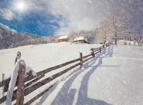 Sunny winter landscape in the mountain village.