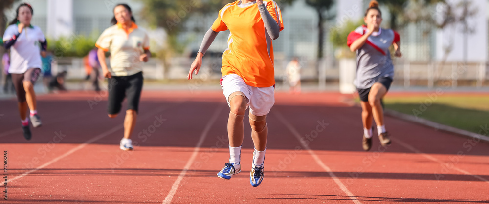 Female runner running in track