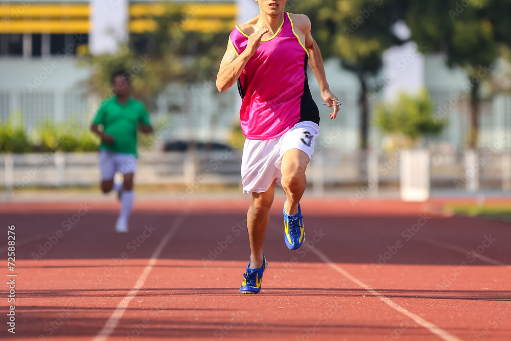 Male runner running in track