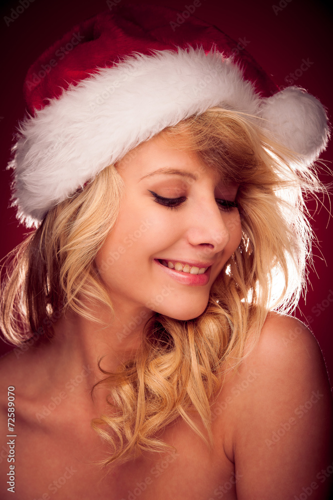 Glamorous young woman with Santa claus hat sending best wishes Glamorous young woman with Santa claus hat sending best wishes