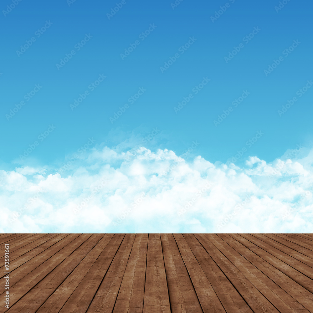 wooden platform and a blue sky with clouds.