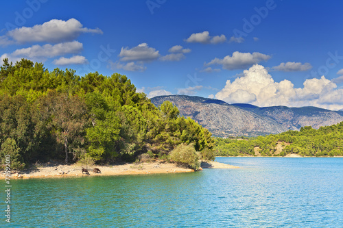 View of the coast and the mountains from the water side. © tacilatan