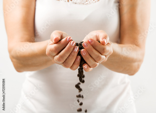 Coffee beans in a women hands