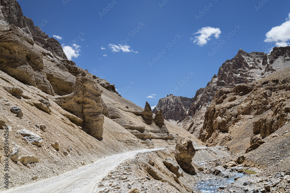 gravel road in mountains nearby river