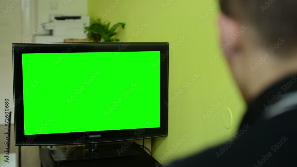Man watches TV(television) - green screen Man watches TV(television) - green screen
