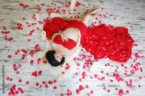 Portrait of a beautiful pregnant woman in red chiffon shawl