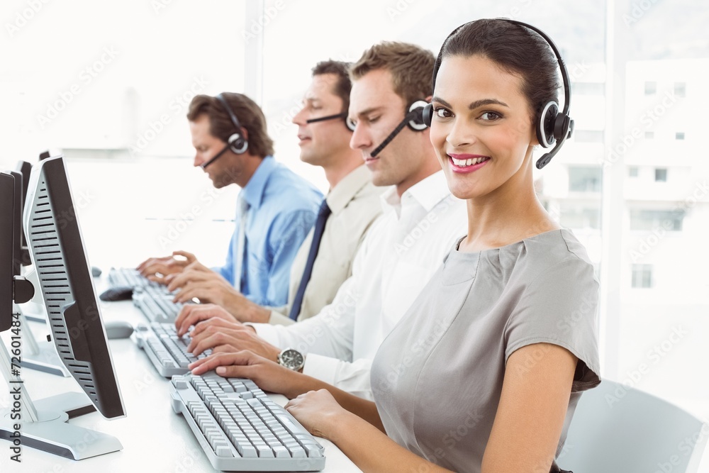 Business people with headsets using computers in office Business people with headsets using computers in office