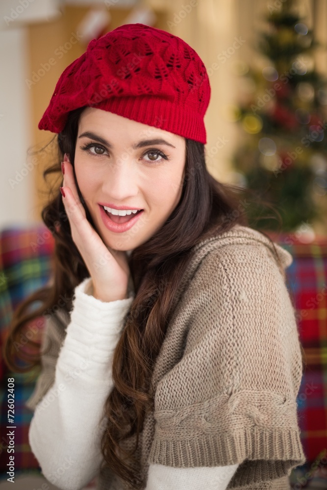 Surprised brunette on the couch at christmas Surprised brunette on the couch at christmas