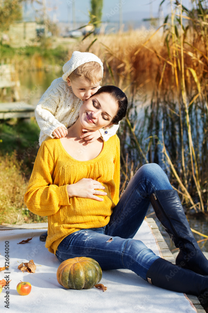 Little boy with her mother on the autumn lake Little boy with her mother on the autumn lake