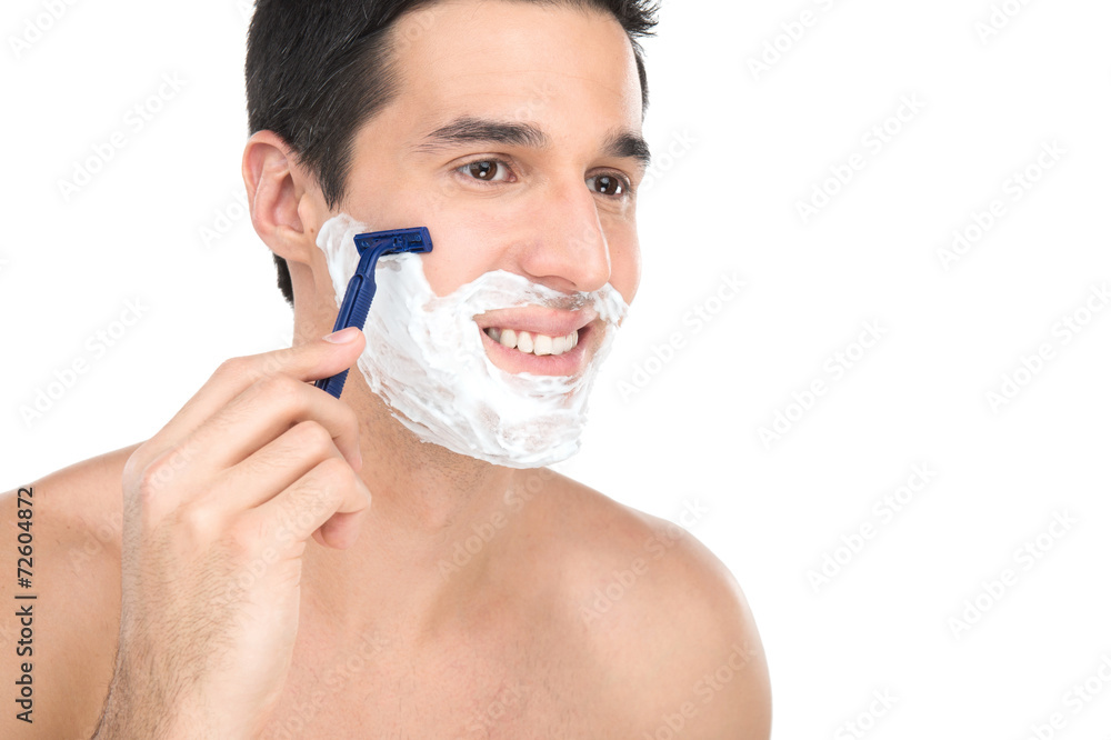 Close up of male shaving with razor on white background.