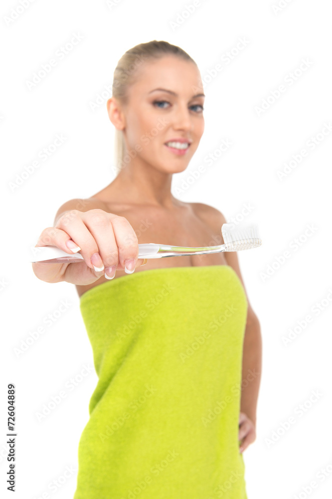 Closeup of toothbrush on foreground with girl smiling Closeup of toothbrush on foreground with girl smiling