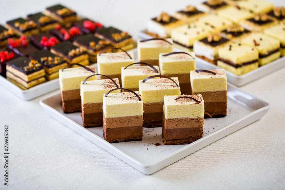 Sweet sliced cakes at white plate Sweet sliced cakes at white plate
