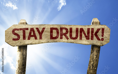 Foto Stay Drunk! wooden sign on a summer day