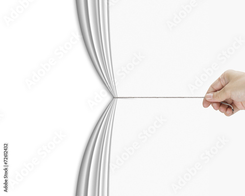 human hand pulling open white blank curtain with empty behind