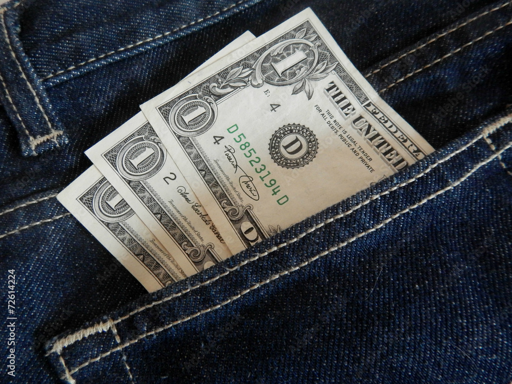 Three banknotes of one dollar in dark blue jeans pocket Three banknotes of one dollar in dark blue jeans pocket