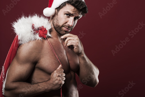 Santa claus with sack full of christmas presents photo