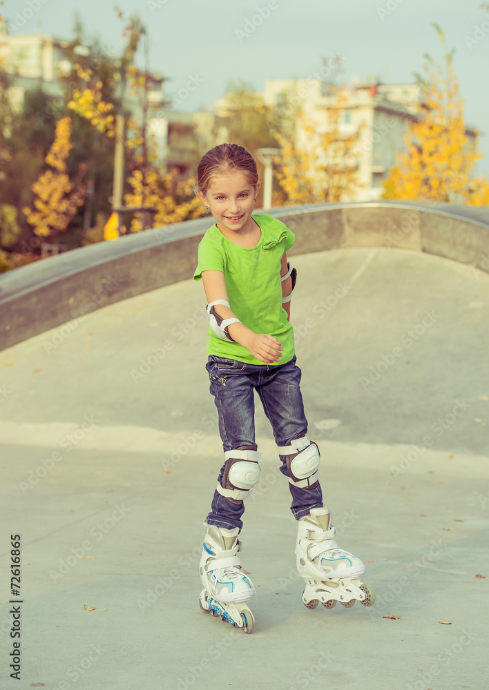 Fototapeta premium Little girl on roller skates
