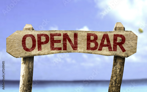 Open Bar wooden sign with a beach on background photo