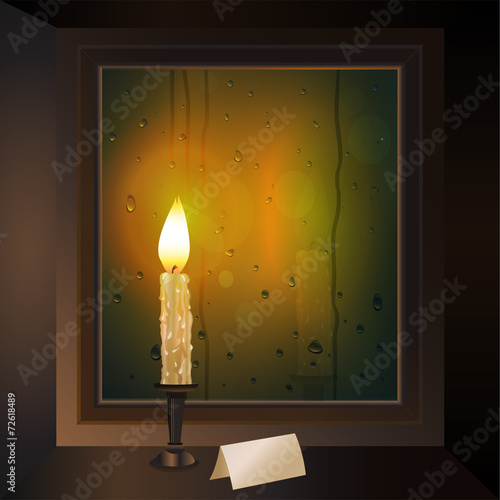 candle burns on the window with a card outside the rain comes