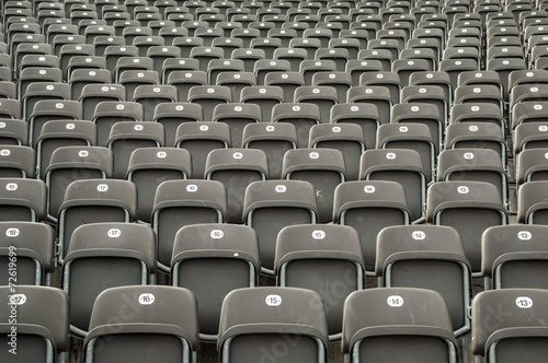 Empty gray plastic seats in a stadium