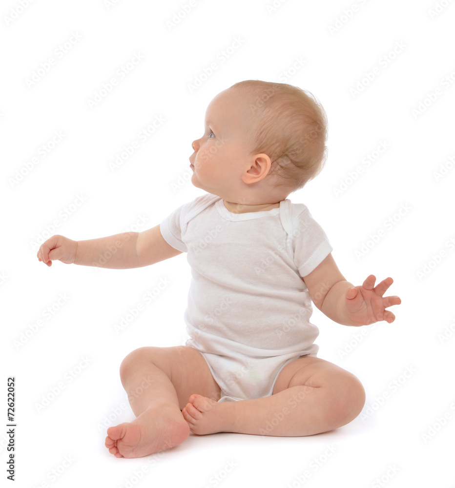 Infant baby toddler sitting hand pointing and looking up Infant baby toddler sitting hand pointing and looking up