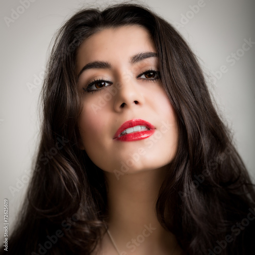 Portrait of a Beautiful Young Brunette Woman Looking into the Ca