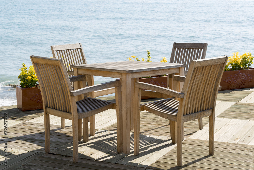 Cafe with wooden tables and chairs at seaside Cafe with wooden tables and chairs at seaside