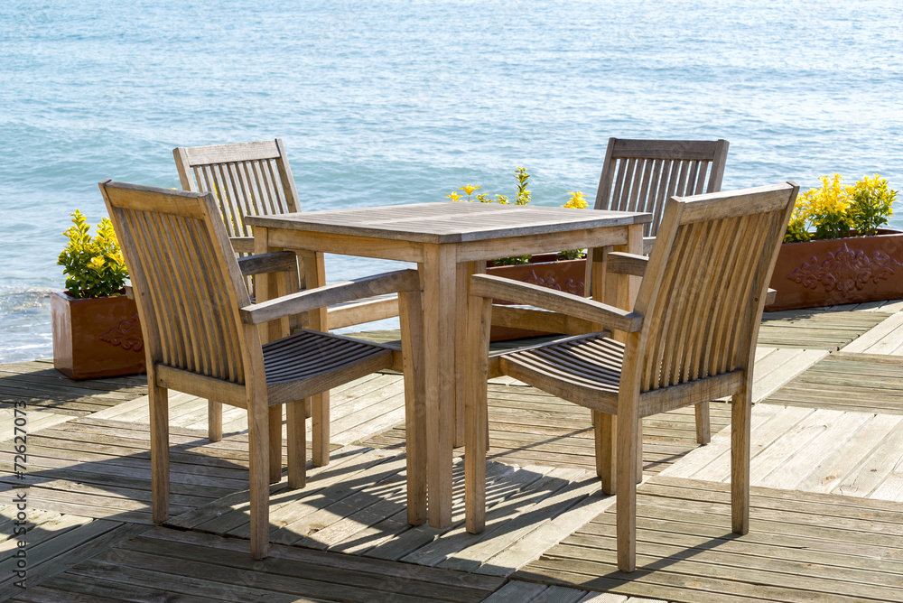 Cafe with wooden tables and chairs at seaside Cafe with wooden tables and chairs at seaside