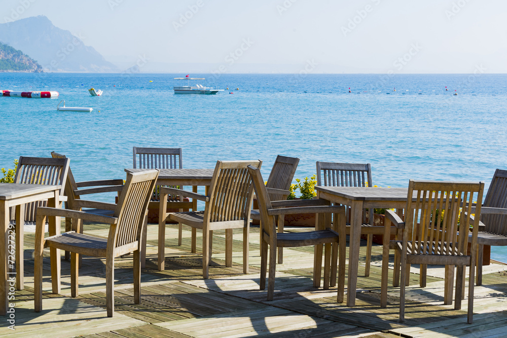 Cafe with wooden tables and chairs at  seaside