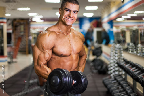 bodybuinder with dumbbell in gym