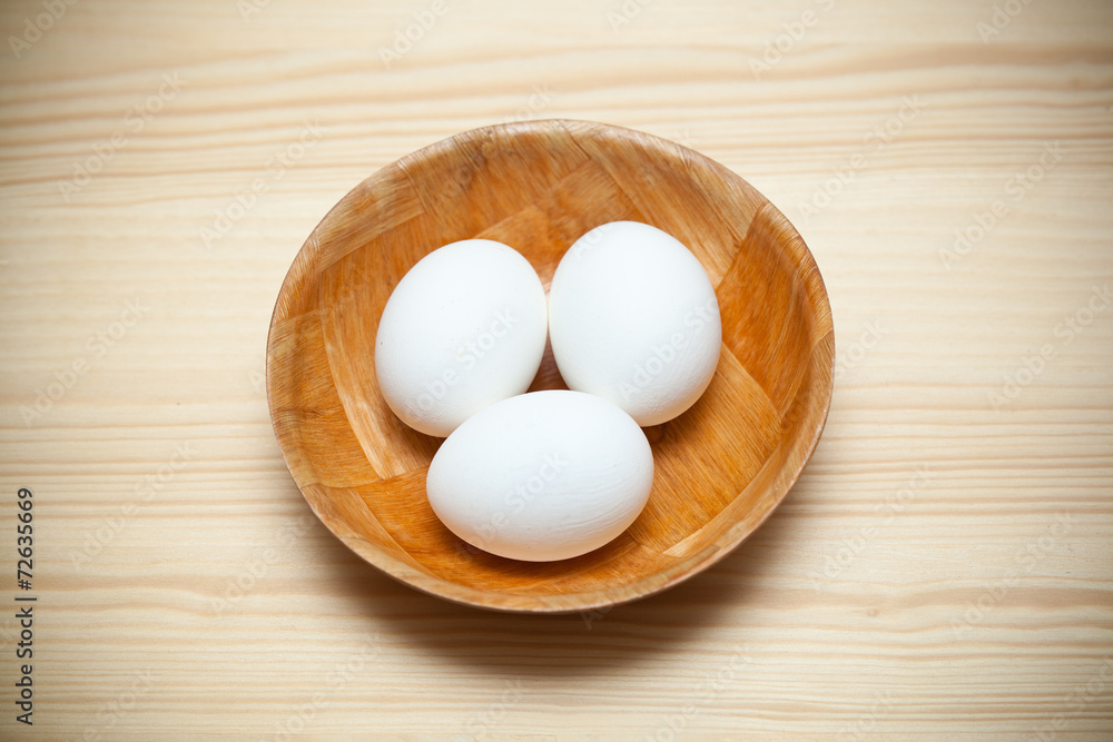 Three white chicken eggs in a plate Three white chicken eggs in a plate